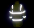 Person walking in a reflective jacket at night